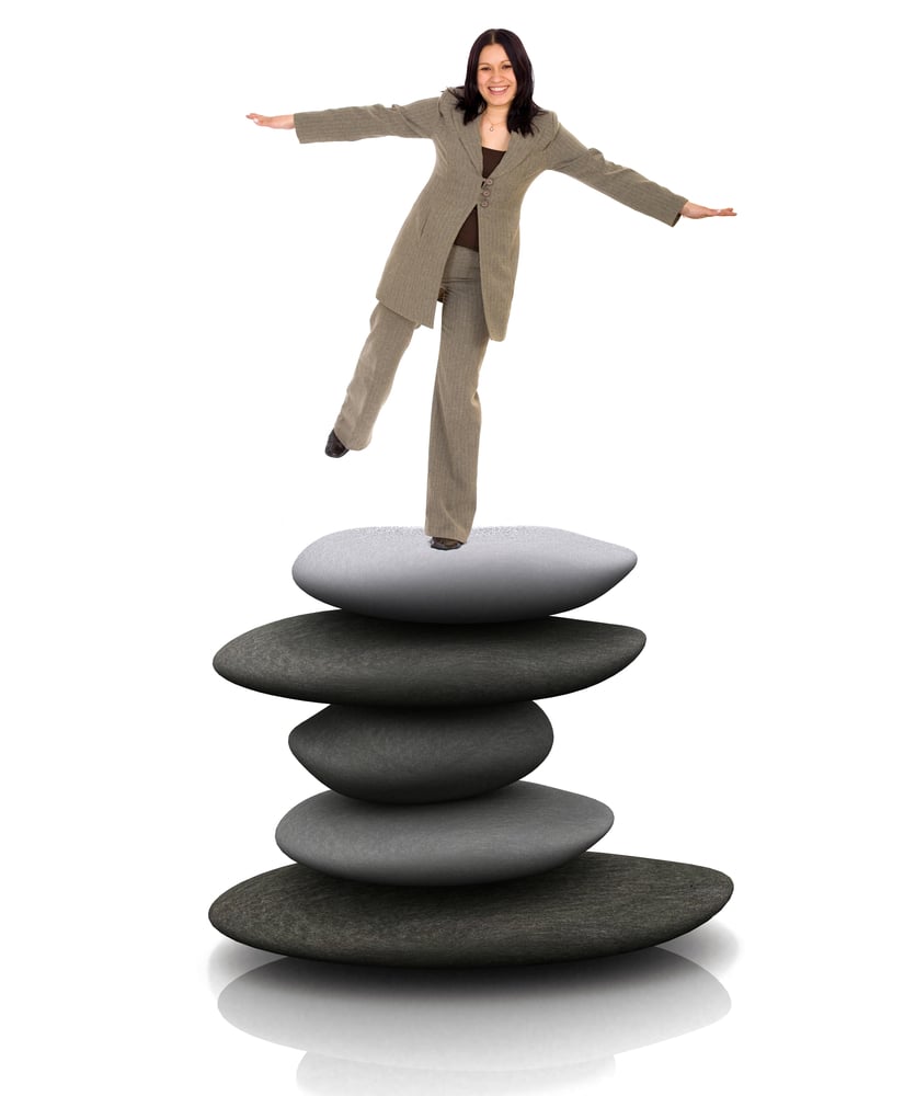 Business woman balancing over stones snd smiling isolated Business woman balancing over stones snd smiling isolated
